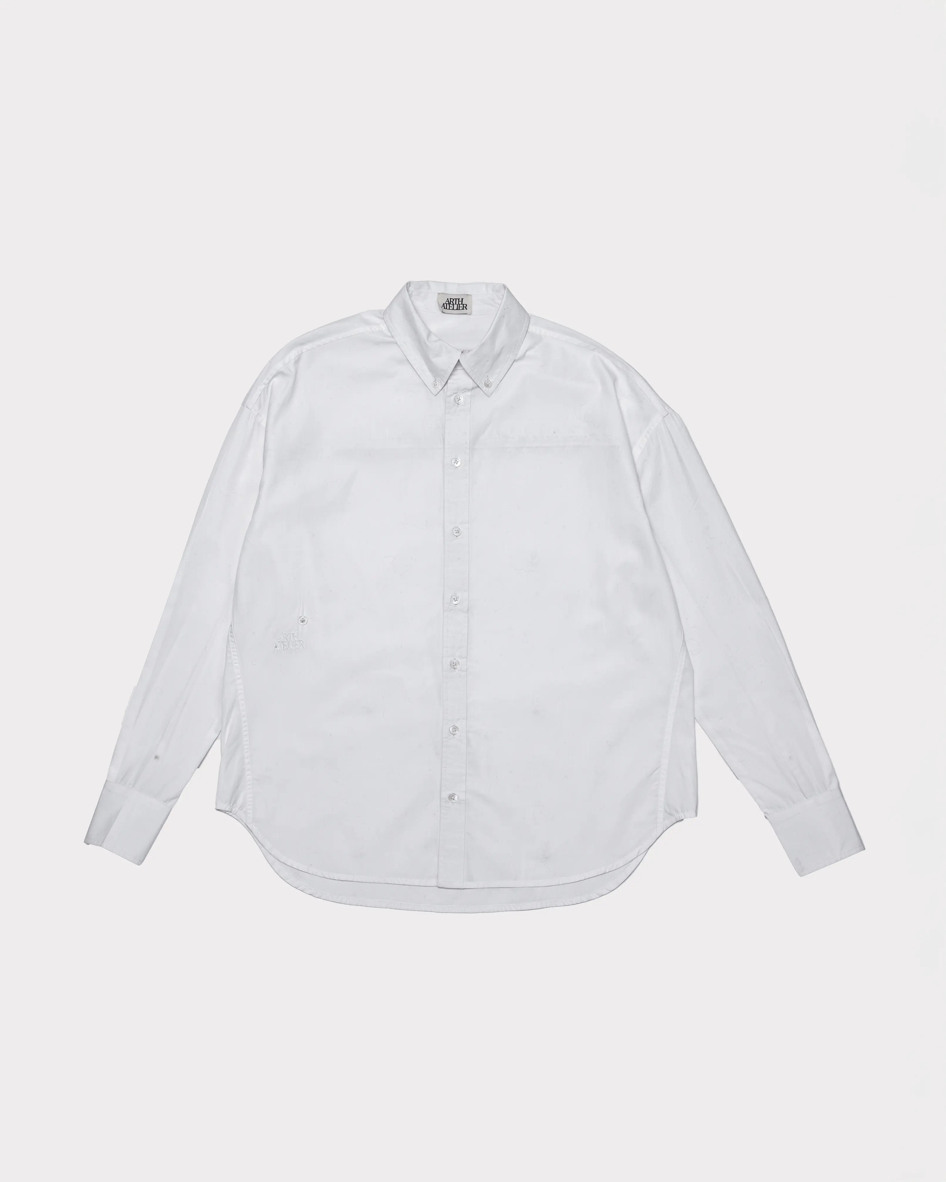 White button-up shirt on a light gray background