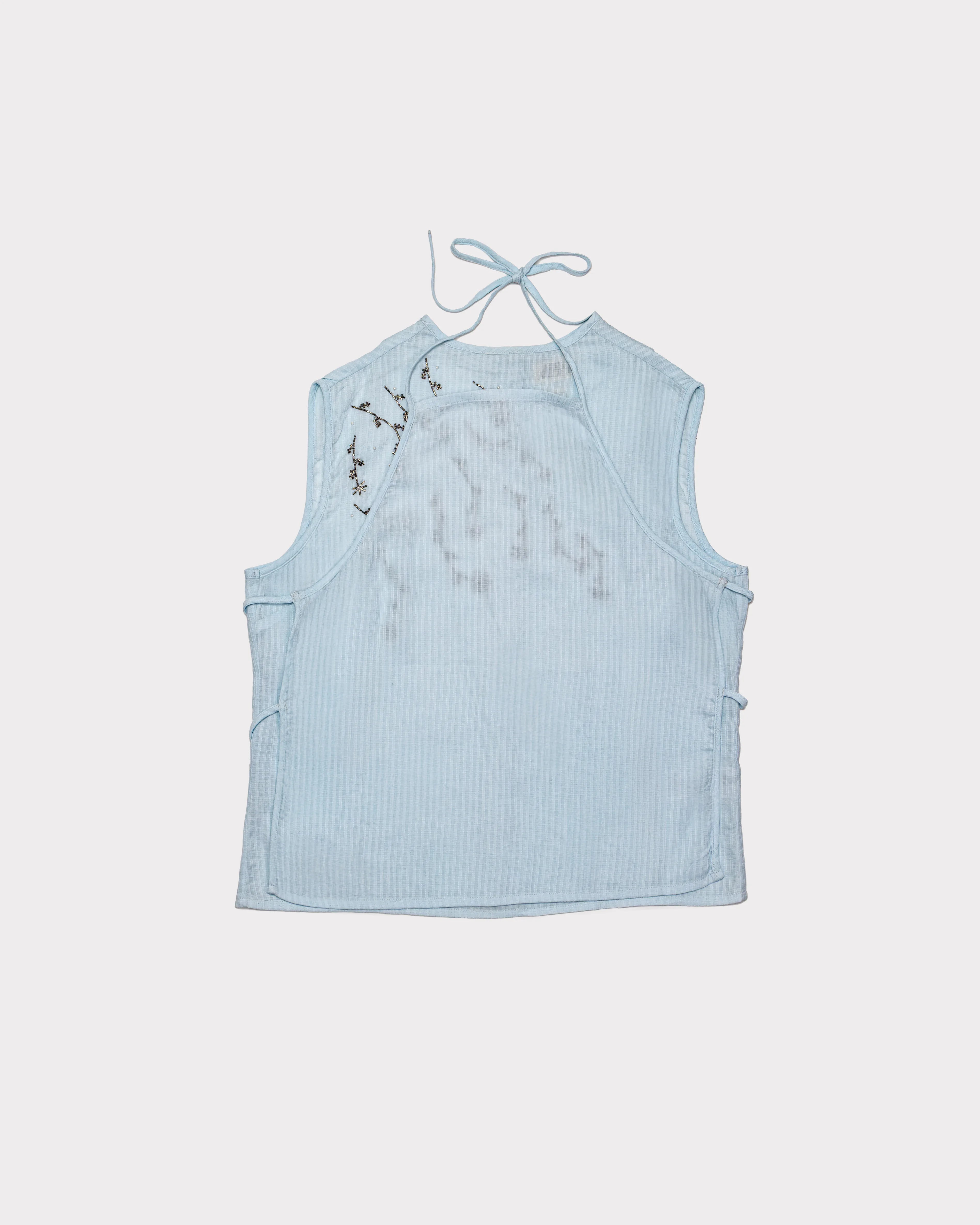 Light blue sleeveless top with floral details on a white background